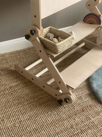Kletterset / Klettertisch NABU with storage basket and wooden toys on a textured carpet surface.
